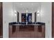 Modern bathroom with double vanities, dark wood cabinets and large mirror at 42383 N 111Th Pl, Scottsdale, AZ 85262
