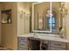 Vanity area with marble countertop and illuminated mirror in a luxurious bathroom at 42383 N 111Th Pl, Scottsdale, AZ 85262