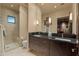 Elegant bathroom with double vanity, a large mirror, and glass shower at 42383 N 111Th Pl, Scottsdale, AZ 85262
