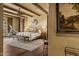 Spacious Primary bedroom with wood floors, large bed, and access to a private balcony at 42383 N 111Th Pl, Scottsdale, AZ 85262