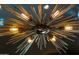 Modern sunburst chandelier with exposed Edison bulb lighting at 42383 N 111Th Pl, Scottsdale, AZ 85262