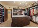 Custom designed walk-in closet with ample shelving and hanging space at 42383 N 111Th Pl, Scottsdale, AZ 85262
