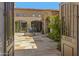Spacious courtyard featuring a stone patio, fountain, and lush greenery at 42383 N 111Th Pl, Scottsdale, AZ 85262