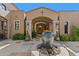 Peaceful courtyard with fountain and arched entryway at 42383 N 111Th Pl, Scottsdale, AZ 85262