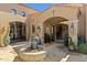 Elegant courtyard entry with fountain, mature plants, and stone flooring at 42383 N 111Th Pl, Scottsdale, AZ 85262
