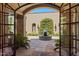 View of courtyard through open arched doorway at 42383 N 111Th Pl, Scottsdale, AZ 85262