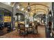 Elegant dining room features a custom bar, a large mural, and a formal dining table at 42383 N 111Th Pl, Scottsdale, AZ 85262
