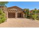 Two-car garage with wooden doors and pergola at 42383 N 111Th Pl, Scottsdale, AZ 85262