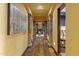 Long hallway with hardwood floors, columns and large artwork at 42383 N 111Th Pl, Scottsdale, AZ 85262