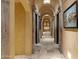 Long hallway with arched entryways and artwork at 42383 N 111Th Pl, Scottsdale, AZ 85262