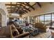 Spacious living room with high ceilings, exposed beams, and large windows at 42383 N 111Th Pl, Scottsdale, AZ 85262