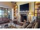 Spacious living room features a fireplace, large windows and built-in shelving at 42383 N 111Th Pl, Scottsdale, AZ 85262