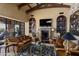 Sophisticated living room with stone fireplace and built-in shelving at 42383 N 111Th Pl, Scottsdale, AZ 85262