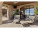 Covered patio boasts comfortable seating and large windows offering scenic views at 42383 N 111Th Pl, Scottsdale, AZ 85262