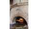 Wood-fired pizza oven with a warm, inviting fire at 42383 N 111Th Pl, Scottsdale, AZ 85262