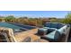 Relaxing pool area with patio furniture and breathtaking mountain views at 42383 N 111Th Pl, Scottsdale, AZ 85262