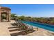 Stunning infinity pool with spa and multiple lounge chairs, offering scenic views at 42383 N 111Th Pl, Scottsdale, AZ 85262
