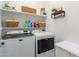 Clean laundry room, complete with shelving and modern appliances at 13384 W Red Range Way, Peoria, AZ 85383