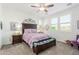 Bright bedroom with a ceiling fan, large windows, and neutral decor at 13384 W Red Range Way, Peoria, AZ 85383