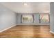 Bright living room featuring light gray walls and wood flooring at 9445 W Pineridge Dr, Sun City, AZ 85351