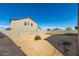 Large backyard with a block wall and a view of a partially built house at 4512 W Suncup Dr, San Tan Valley, AZ 85144
