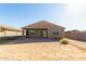 House's backyard with a covered patio and desert landscaping at 4512 W Suncup Dr, San Tan Valley, AZ 85144