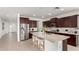 Modern kitchen with granite countertops, dark cabinets, and stainless steel appliances at 4512 W Suncup Dr, San Tan Valley, AZ 85144