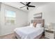 Bright bedroom with a comfortable bed, nightstands, and ceiling fan at 4512 W Suncup Dr, San Tan Valley, AZ 85144