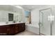 Elegant bathroom with double vanity, soaking tub, and walk-in shower at 4512 W Suncup Dr, San Tan Valley, AZ 85144