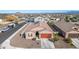 Aerial view of house with solar panels and two-car garage in a neighborhood at 4512 W Suncup Dr, San Tan Valley, AZ 85144