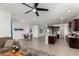 Open concept kitchen with island, dark cabinetry, and granite countertops at 4512 W Suncup Dr, San Tan Valley, AZ 85144