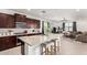 Modern kitchen with granite countertops, dark cabinets, and stainless steel appliances at 4512 W Suncup Dr, San Tan Valley, AZ 85144