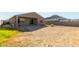 Backyard with covered patio, grassy area, and mountain view at 4512 W Suncup Dr, San Tan Valley, AZ 85144