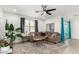 Bright living room featuring a comfortable sectional sofa and large TV at 4512 W Suncup Dr, San Tan Valley, AZ 85144