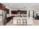 Modern kitchen with granite island, dark cabinets, and stainless steel appliances at 4512 W Suncup Dr, San Tan Valley, AZ 85144