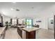 Open concept kitchen with island, stainless steel appliances, and ample counter space at 4512 W Suncup Dr, San Tan Valley, AZ 85144