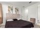 Spacious bedroom with a queen bed, neutral carpeting, and an ensuite bathroom at 4512 W Suncup Dr, San Tan Valley, AZ 85144