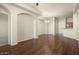 Open living room with hardwood floors and kitchen access at 14575 W Mountain View Blvd # 11312, Surprise, AZ 85374