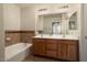 Double vanity bathroom with a large soaking tub at 14575 W Mountain View Blvd # 11312, Surprise, AZ 85374