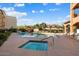 Community pool and spa with lounge chairs at 14575 W Mountain View Blvd # 11312, Surprise, AZ 85374