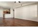 Open concept living room with hardwood floors and kitchen view at 14575 W Mountain View Blvd # 11312, Surprise, AZ 85374