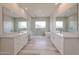 Spa-like bathroom with double vanities, soaking tub, and shower at 14930 W El Cortez Pl, Surprise, AZ 85387