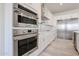 Kitchen with stainless steel appliances and white cabinetry at 14930 W El Cortez Pl, Surprise, AZ 85387