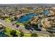 Aerial view of a community with lake, pool, and homes at 242 E Stonebridge Dr, Gilbert, AZ 85234