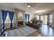 Living room with fireplace, hardwood floors, and a comfy seating area at 242 E Stonebridge Dr, Gilbert, AZ 85234