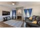 Living room with a fireplace, hardwood floors and large windows at 242 E Stonebridge Dr, Gilbert, AZ 85234