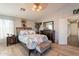 Spacious bedroom with a king-size bed and access to a hallway at 242 E Stonebridge Dr, Gilbert, AZ 85234