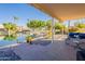 Relaxing patio overlooking a lake with seating and landscaping at 242 E Stonebridge Dr, Gilbert, AZ 85234