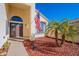 Inviting home exterior with attractive landscaping and double entry doors at 242 E Stonebridge Dr, Gilbert, AZ 85234