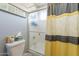 Bathroom with a shower/tub combo, neutral color scheme, and frosted glass door at 242 E Stonebridge Dr, Gilbert, AZ 85234